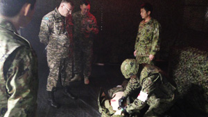 Kazakhstan military members observe a medical emergency exercise at the JSDF Medical School.
