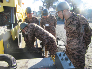Mongolian personnel operating an asphalt finisher for the first time