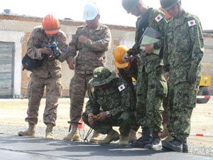 The Mongolian Army watch over controlling the temperature of asphalt