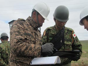 The site supervisor of the Mongolian team confirming the progression status of work with GSDF officer