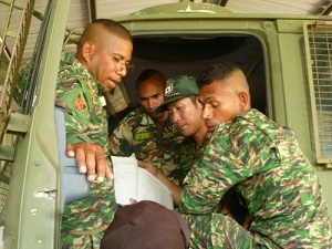 A GSDF member provides guidance to F-FDTL members