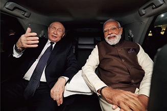 印露首脳会談の前に、車で移動し会話をするプーチン大統領とモディ首相（2025年12月）【AFP＝時事】